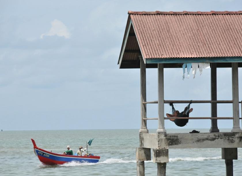 A fisherman seen having a rest after coming back from the daily catch at Teluk Kumbar fisherman jetty, Penang. — Picture by KE Ooi