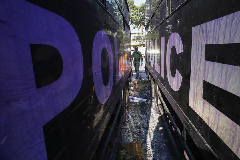 A Thai security personnel inspects destroyed police trucks at the Thai-Japan youth stadium, the site of fierce clashes between anti-government protester and riot police, in central Bangkok December 27, 2013. u00e2u20acu201d Reuters pic