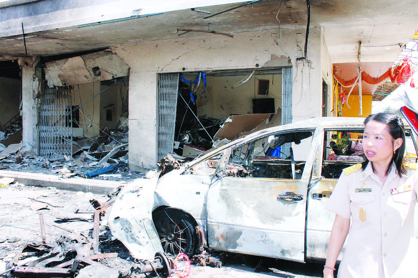 Local residents look at the scene of the bombing. u00e2u20acu201d Oriental Daily pic
