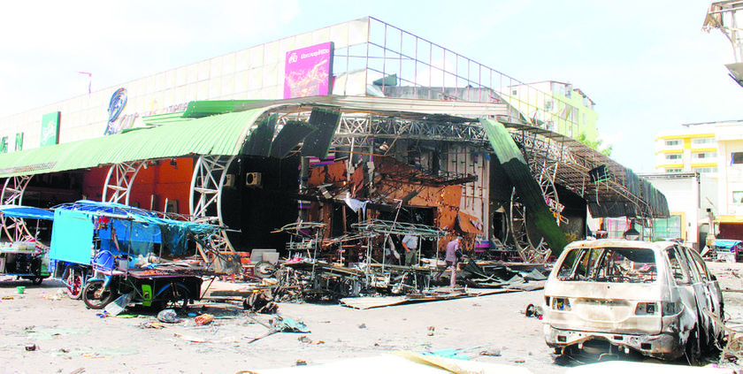 A car and store front were destroyed in one of the explosions. u00e2u20acu201d Oriental Daily pic