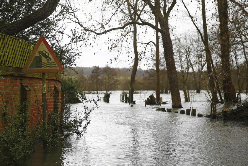 A danger sign is seen as water from the Thames River floods the village of Medmenham, southern England February 12, 2014. u00e2u20acu201d Reuters pic