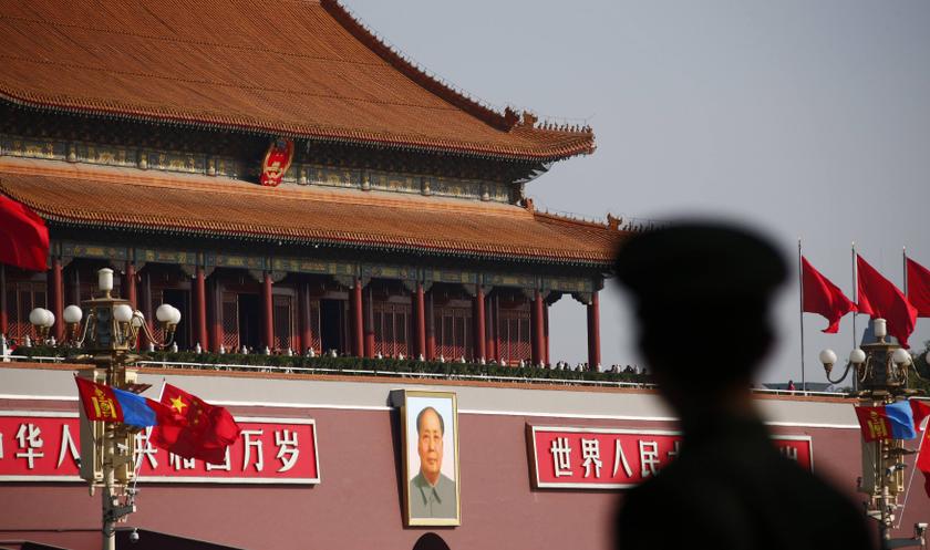 A paramilitary policeman stands guard on Tiananmen Square that is decorated with Chinese and Mongolian national flags outside the Great Hall of the People in Beijing October 25, 2013.  u00e2u20acu201d Reuters pic