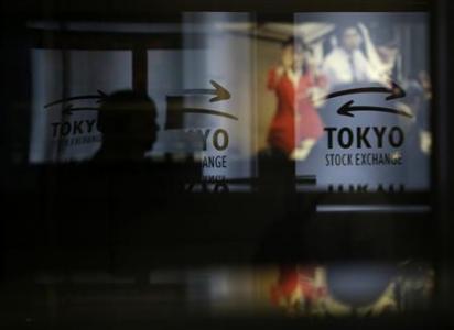 A visitor walks past logos at the Tokyo Stock Exchange in Tokyo June 13, 2013. u00e2u20acu201d Reuters pic
