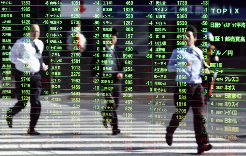 Pedestrians are reflected on a stock quotation board at a brokerage in Tokyo November 26, 2013. u00e2u20acu201d Reuters pic