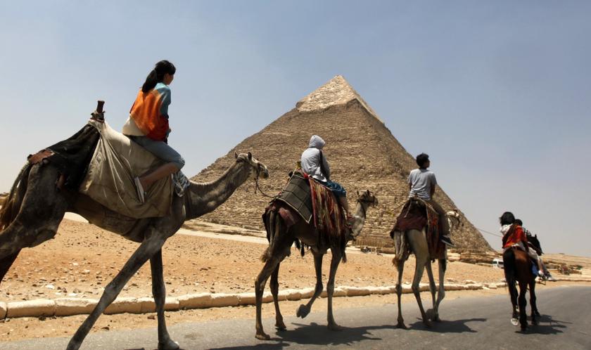 Tourists ride a horse and camels at the Giza Pyramids on the outskirts of Cairo July 24, 2013.u00c2u00a0u00e2u20acu201dReuters pic