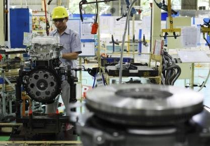 A worker installs a machine block at Toyota Motor Manufacturing Indonesiau00e2u20acu2122s plant in Jakarta February 12, 2013. u00e2u20acu201d Reuters pic