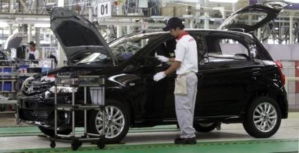 A worker checks a new Toyota Etios Valco at the new Toyota plant in Karawang in Indonesia’s West Java province on March 15, 2013. — Reuters pic