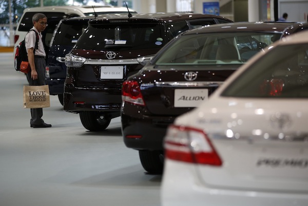 A visitor looks at Toyota Motor Corpu00e2u20acu2122s cars at the company's showroom in Tokyo August 1, 2013. u00e2u20acu201d Reuters pic