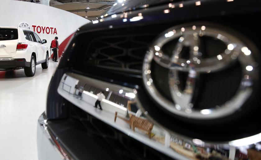A showroom staff member works under the logo of Toyota Motor Corp, between cars displayed at its showroom in Tokyo February 4, 2014. u00e2u20acu2022 Reuters pic