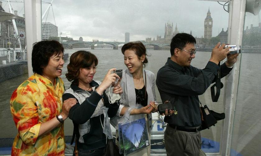 Chinese tourists on the River Thames in London. Photo: Reuters 