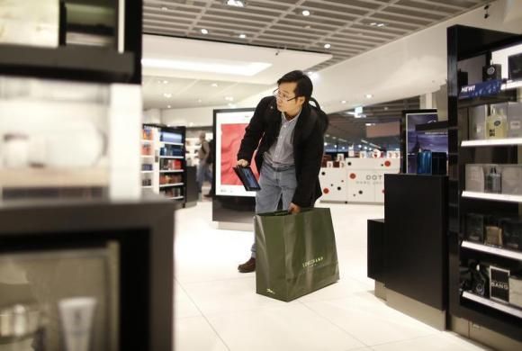 A man with a tablet computer shops in a duty free store at the Fraport airport in Frankfurt November 14, 2012 Reuters