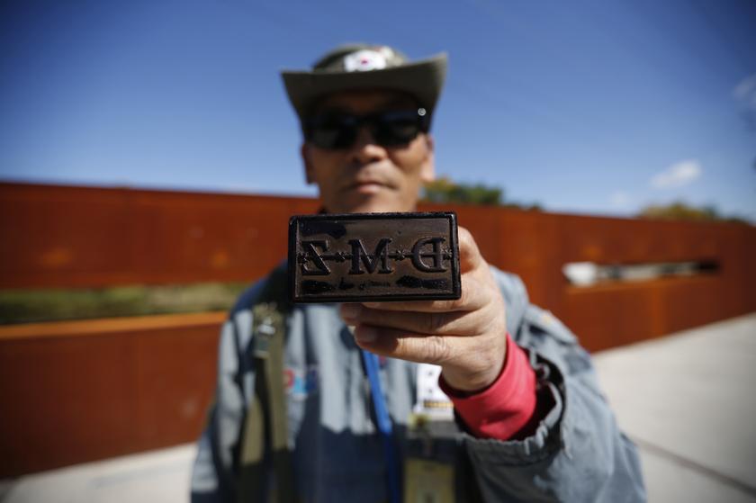 A tour guide poses for photographs with a stamp for tourists at the Imjingak pavilion near the demilitarized zone which separates the two Koreas, in Paju, north of Seoul October 16, 2013. u00e2u20acu201d Reuters pic