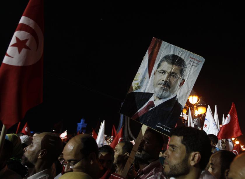 Supporters of the Islamist Ennahda movement hold a portrait of ousted Egyptian president Mohamed Morsi during a rally at Kasbah Square in Tunis August 3, 2013
