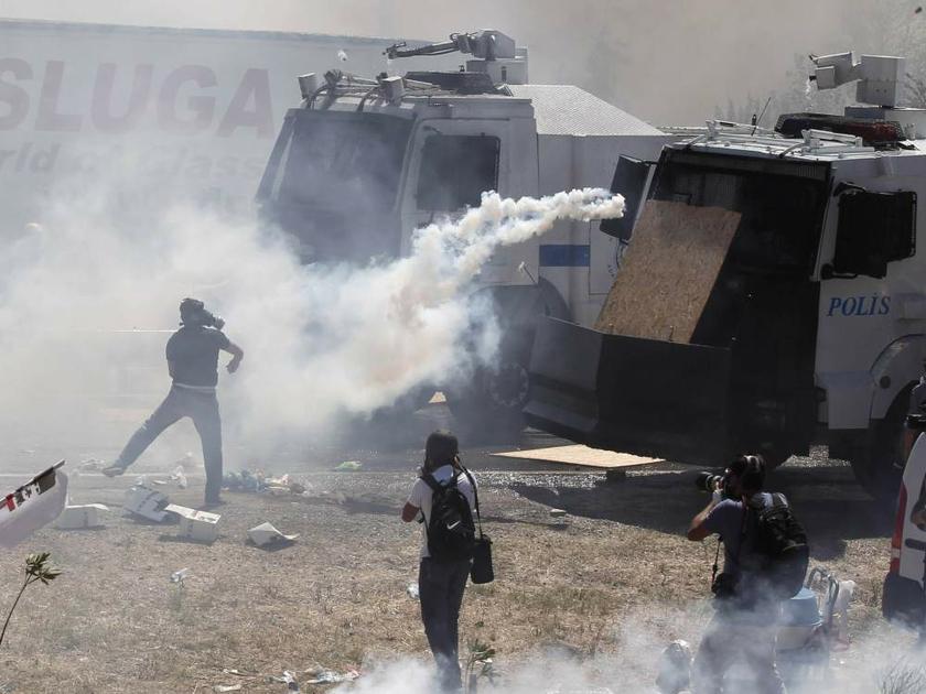 A protester runs to throw a tear gas canister back during clashes with riot police as they try to march to a courthouse in Silivri, Turkey, on August 5, 2013. u00e2u20acu201d Reuters pic
