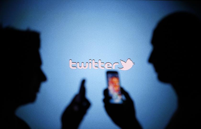 Men are silhouetted against a video screen with a Twitter logo as they pose with Samsung S3 and S4 smartphones in this photo illustration taken in the central Bosnian town of Zenica on August 14, 2013. u00e2u20acu201d Reuters pic