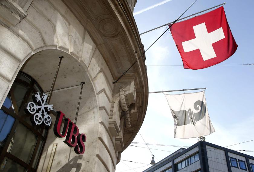 A Swiss national flag and a flag of the city of Basel fly over the entrance of a branch office of Swiss bank UBS in Basel October 22, 2013. u00e2u20acu201d Reuters pic