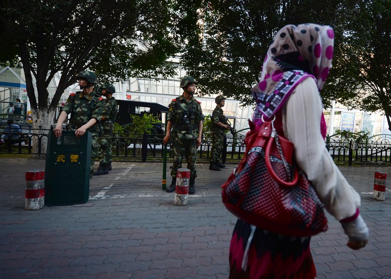 Chinese paramilitary police stand guard in the Muslim Uighur minority area of Urumqi, Xinjiang Province on June 30, 2013. u00e2u20acu201c AFP pic