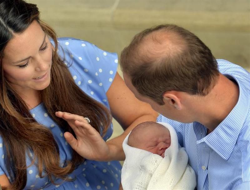 Britain's Prince William holds his baby son outside the Lindo Wing of St Mary's Hospital before leaving with Catherine, Duchess of Cambridge (L), in central London July 23, 2013