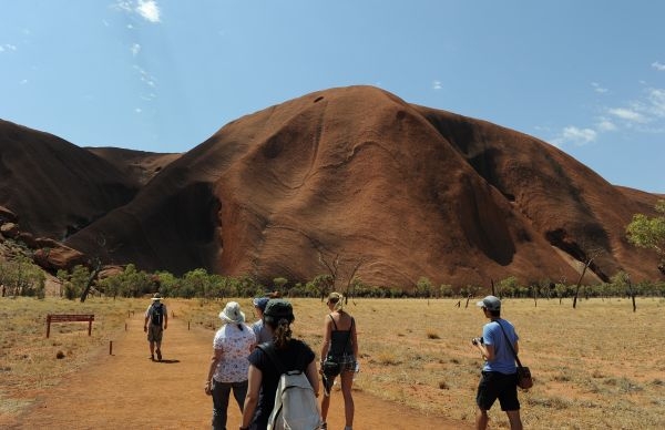 Tourists (below) walking towards Uluru, formerly known as Ayers Rock. u00e2u20acu201d AFP pic