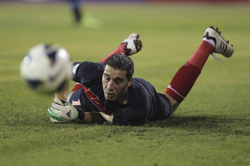 Jordan's goalkeeper Mohamad Shatnawi dives in an attempt to save a shot during their World Cup qualifying playoff first leg match against Uruguay at Amman International stadium November 13, 2013. u00e2u20acu201d Reuters pic