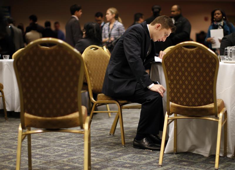A job seeker fills out forms at a table while attending a career fair with prospective employers in New York City, October 24, 2012. u00e2u20acu201d Reuters pic