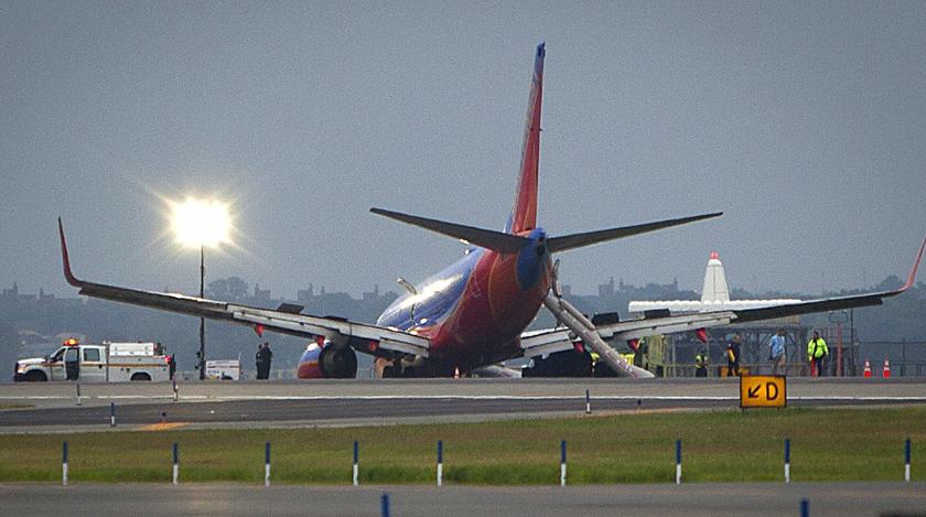 A Southwest Airlines Boeing 737 sits on the tarmac at LaGuardia airport, after making an emergency landing without its nose gear, in New York July 22, 2013