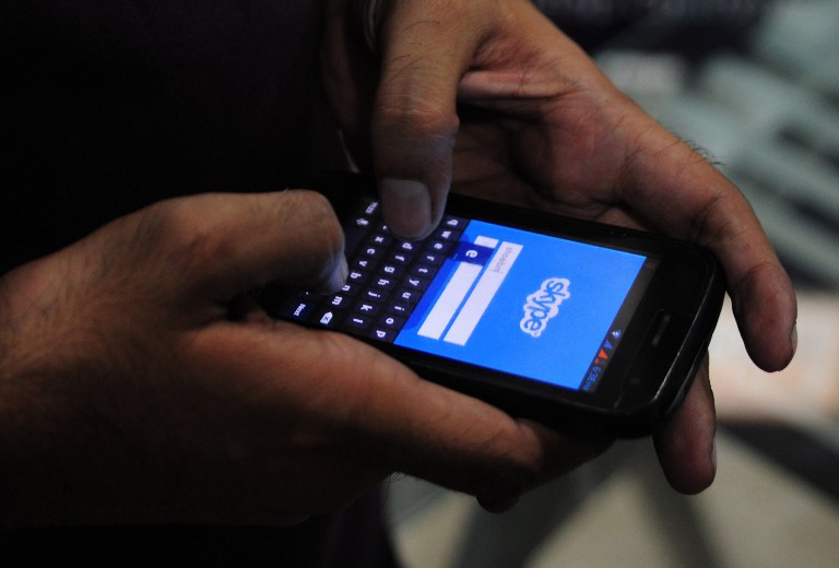 A Pakistan man tries to connect to the Skype network on his mobile in the port city of Karachi on October 3, 2013. Pakistan's southern Sindh province will block access to online communication networks including Skype and WhatsApp for three months in a bid