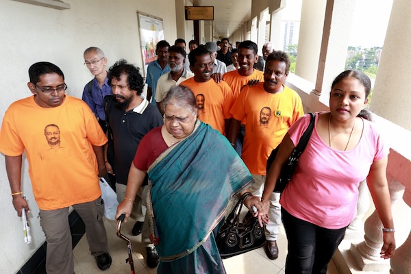 P. Uthayakumaru00e2u20acu2122s wife, S. Indra Devi, and his mother, G. Kalaivani are flanked by supporters as they leave the courtroom at the Duta court complex in Kuala Lumpur September 24, 2013. u00e2u20acu201d Picture by Saw Siow Feng