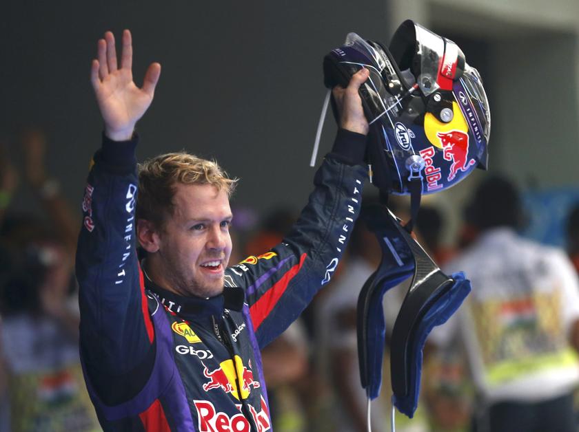 Red Bull Formula One driver Sebastian Vettel (C) of Germany celebrates winning the Indian F1 Grand Prix at the Buddh International Circuit in Greater Noida, on the outskirts of New Delhi, October 27, 2013. Reuters pic