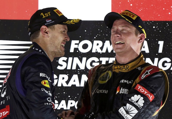 Red Bull Formula One driver Sebastian Vettel of Germany celebrates on the podium with Lotus F1 Formula One driver Kimi Raikkonen of Finland after the Singapore F1 Grand Prix in Singapore September 22, 2013. u00e2u20acu201d Reuters pic