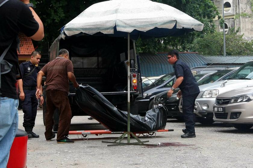 Police taking the body of Arab-Malaysian Development Bank founder Hussain Ahmad Najadi to hospital. He was killed by a gunman in the heart of Kuala Lumpur on July 29, 2013. u00e2u20acu201d The Malay Mail pic