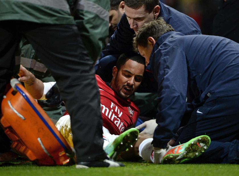 Arsenal's Theo Walcott holds shows his agony as he is injured during their English FA Cup  match against Tottenham Hotspur at the Emirates stadium in London, January 4, 2014. u00e2u20acu201d Reuters pic