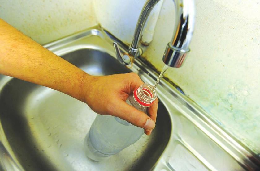 A Petaling Jaya resident holds a 1.5-litre bottle, which some complain takes a whole day to fill. u00e2u20acu201d Picture from The Malay Mail