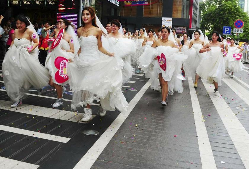 Women in wedding gowns participate in a bridesu00e2u20acu2122 race event organised by a shopping mall to celebrate the upcoming Qixi Festival in Guangzhou, China on August 12, 2013. u00e2u20acu201d Reuters pic