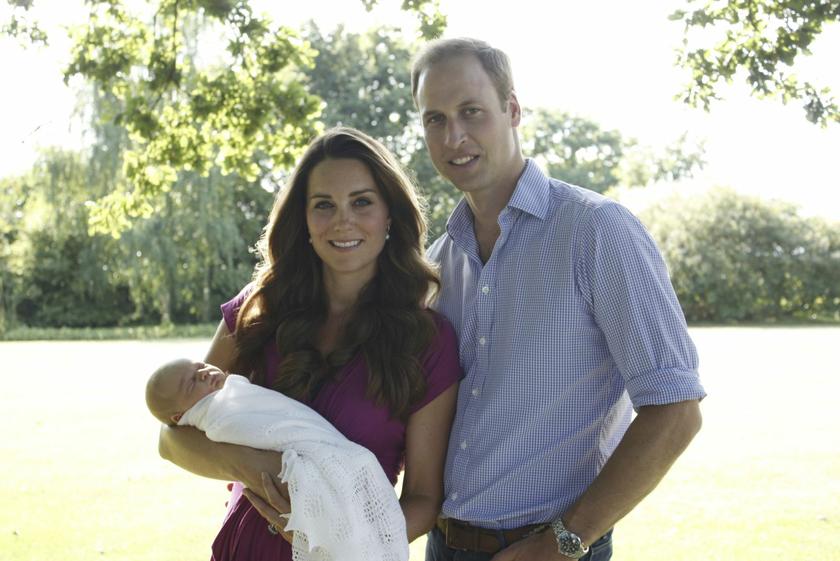Prince William and his wife Catherine, Duchess of Cambridge, pose in the garden of the Middleton family home in Bucklebury, southern England, with their son Prince George, in this undated photograph released in London August 19, 2013