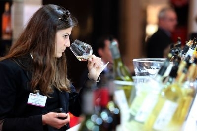 A woman tastes wine during the Vinexpo trade fair in Bordeaux on June 20, 2013. u00e2u20acu201d AFP pic