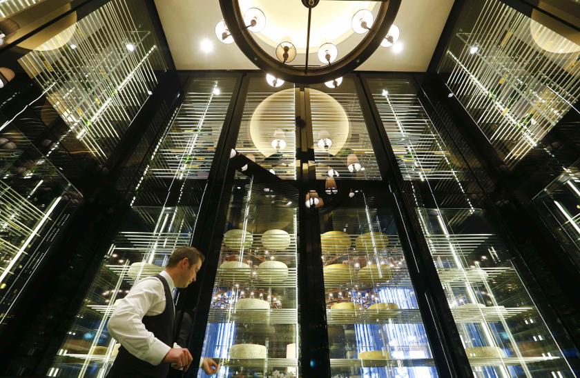 A waiter stands in a storage room for cheese and wine in a restaurant of the Chedi Andermatt hotel during a media preview in the central Swiss town of Andermatt, some 30km south of Altdorf, December 9, 2013.u00c2u00a0u00e2u20acu201d Reuters pic