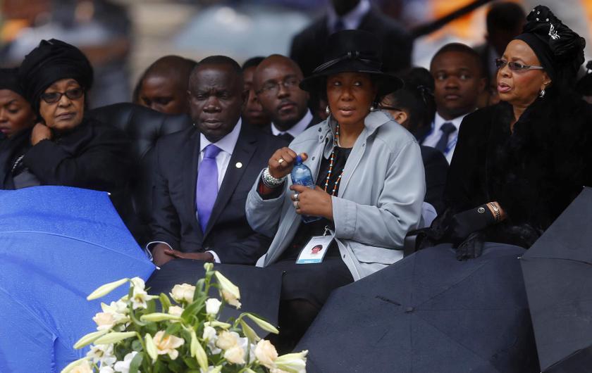 Former South African President Nelson Mandela ex-wife Winnie Mandela (left), wife Graca Machael (right) and other family members attend the official memorial service for Nelson Mandela at the First National Bank football stadium, also known as Soccer City