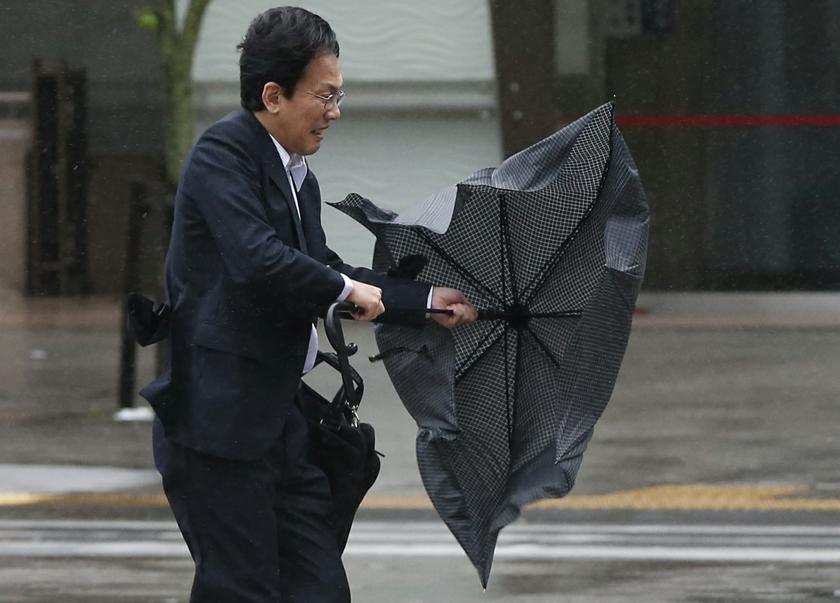 A man struggles against strong wind and rain caused by approaching Typhoon Wipha at a business district in Tokyo October 16, 2013. u00e2u20acu201du00c2u00a0Reuters pic