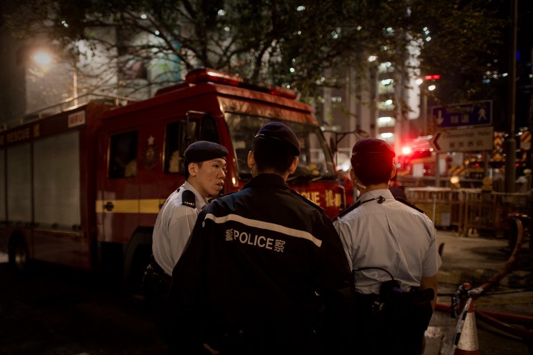 Policemen are seen near the site where a World War II-era bomb weighing almost a tonne was discovered in Hong Kong on February 6, 2014. u00e2u20acu201d AFP pic