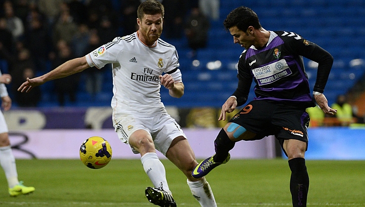 File photo shows Real Madridu00e2u20acu2122s midfielder Xabi Alonso (left), vies with Valladolidu00e2u20acu2122s forward Javi Guerra during the Real Madrid CF vs Real Valladolid CF match at the Santiago Bernabeu stadium in Madrid, on Nov 30, 2013. u00e2u20acu201d AFP pic