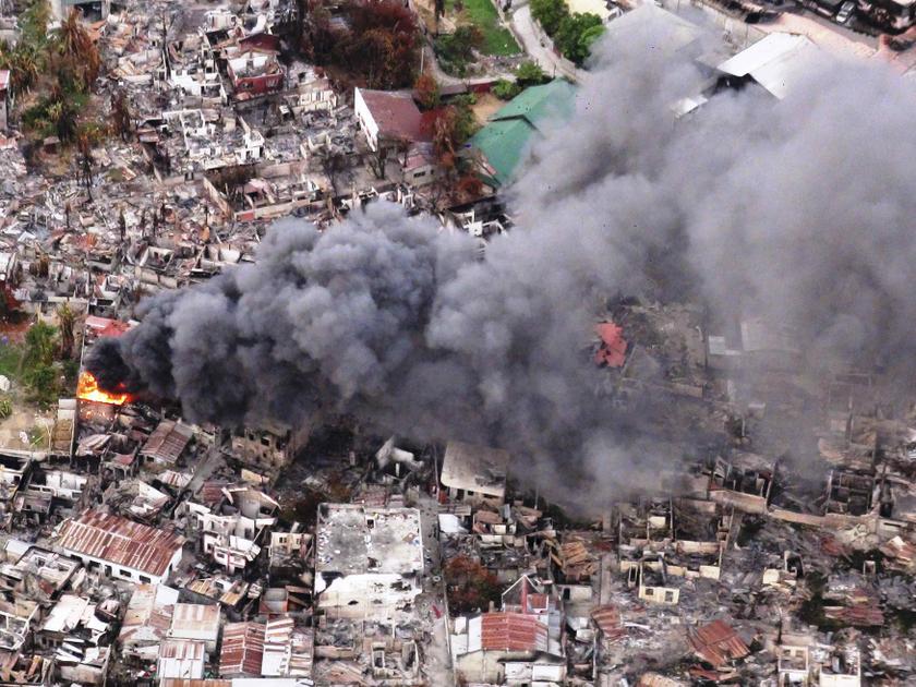 An aerial view of burning houses caused by fires from fighting between government soldiers and Muslim rebels of the Moro National Liberation Front downtown of Zamboanga city in southern Philippines September 25, 2013. u00e2u20acu201d Reuters pic
