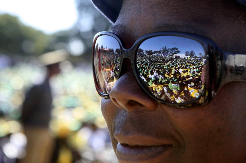 Supporters of Zimbabwean President Robert Mugabe's ZANU-PF party are reflected in a pair of sunglasses during an election rally in Marondera, about 70km east of Harare July 15, 2013. u00e2u20acu201c Reuters pic