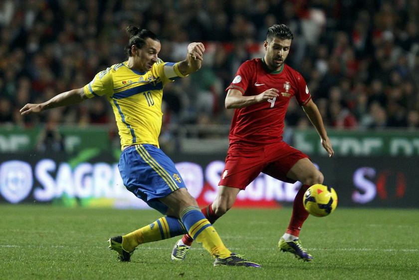Swedenu00e2u20acu2122s Zlatan Ibrahimovic and Portugalu00e2u20acu2122s Miguel Veloso challenge for the ball during their 2014 World Cup first leg qualifying playoff match at Luz stadium in Lisbon November 15, 2013. u00e2u20acu201d Reuters pic